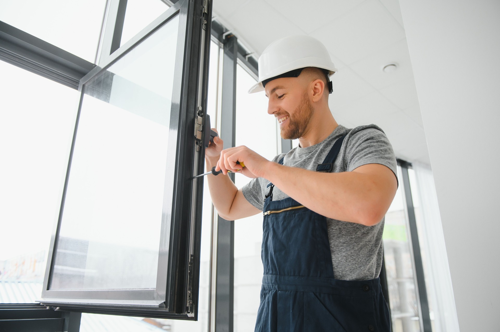 Professional master at repair and installation of windows, at work.